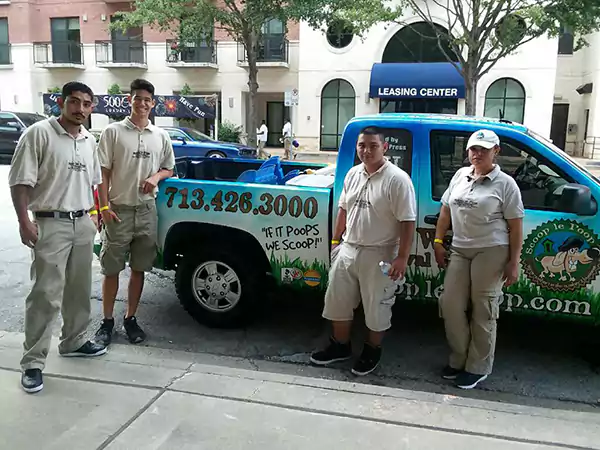 A few Scoop le Poop Pet Waste Removal Specialists on the job and standing by the company truck.
