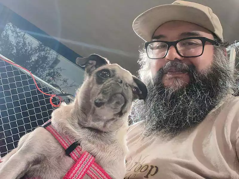 Scoop le Poop employee, Jacob, with a happy pup customer